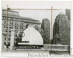 [Worker painting courthouse dome]