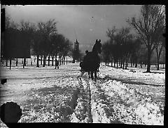Views: Brooklyn, Long Island, Staten Island. Brooklyn scenes; buildings. View 003: Eastern Parkway (streetscape, man on horse-drawn carriage in snow).