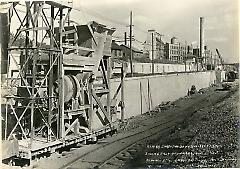 Looking east showing retaining wall between 5th and 6th Ave. and concrete making machinery