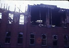 [Building facade with top floor destroyed]