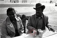 [Couple and child on Coney Island boardwalk]