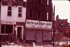 [Bushwick storefronts with rubble outside]