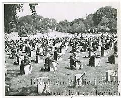 [Boy Scouts and Cub Scouts tending headstones]