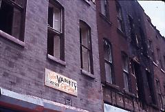 [Side view of damaged townhouses]