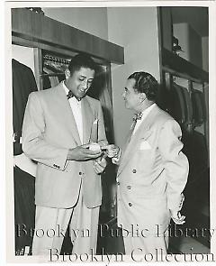 [Don Newcombe in clothing store]