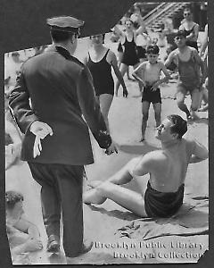 [Policeman warns man at Coney Island beach]