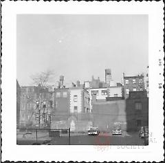 [Parking lot on Clinton Street with view of backs of houses on Monroe Place.]