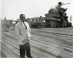 [Man in white suit jacket and sunglasses at Brooklyn Navy Yard]