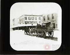 [Horse-drawn carriage in snow-covered street]