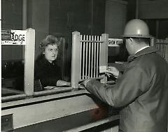 [Worker showing his badge]