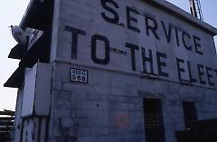 [Old sign on the wall, "service to the fleet"]