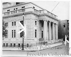 [Former courthouse in Sunset Park with wooden barrier at entrance]