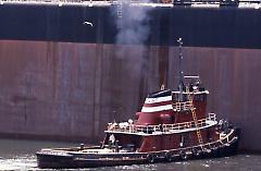 [T.T. Stuyvesant ship leaving with tugboat]
