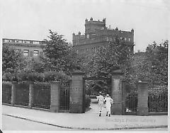 [Two women entering gate at Pratt Institute]