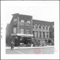 [Southeast corner of 6th Avenue (side showing) and 7th Street.]