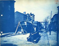 [Street in Brooklyn Heights with derrick and construction shed]