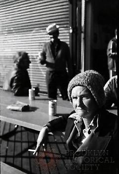 [Woman and men on Coney Island boardwalk]