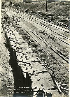 Showing foundation for retaining wall between 7th and 8th Aves. looking east from 7th Ave.