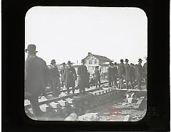 [Men standing on railroad tracks at moving of Hotel Brighton]