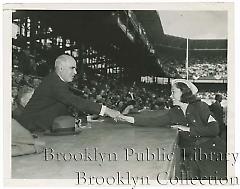 [Woman and man shaking hands at World Series game]