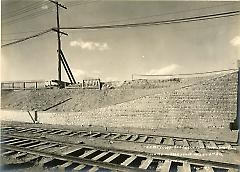 Showing cobblestone wall at 6th Ave. looking north west