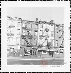 [At far left, portion of E. Maliha & Sons Cabinetmakers.]