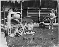 [Five orphan children in wading pool]