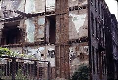 [Side view of destroyed townhouse]