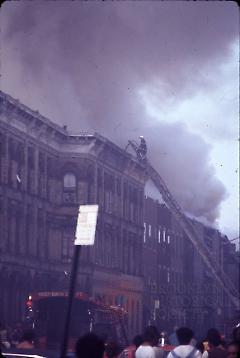 [Fighting a fire on the roof of a townhouse]