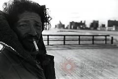 [Man smoking on boardwalk]