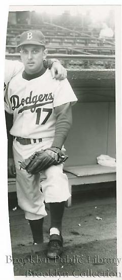 [Carl Erskine posing in dugout]