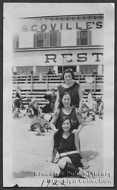 [Three young women on Coney Island beach in front of Scoville's Rest(aurant)]