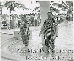 [Two corpulent men in swimming pool]