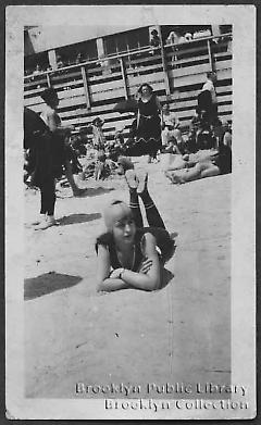 [Young woman lying on Coney Island beach]