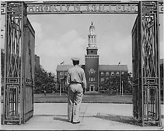 [Soldier standing at main gate of Brooklyn College]