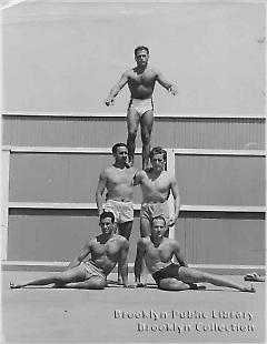 [Five bodybuilders at beach]