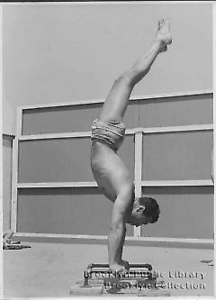 [Young man doing gymnastics]