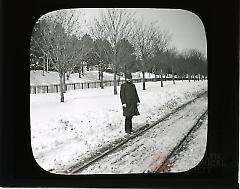 [Man standing by train tracks after the blizzard]