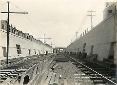 Looking east from 18th Ave. showing arches, retaining walls, fence and roadbed