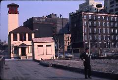 [Man on pier in front of Fulton Ferry Fireboat House]