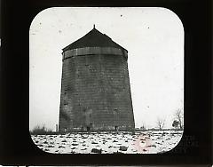 [Windmill in snow-covered field]