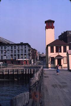 [Woman on pier in front of renovated Fulton Ferry Fireboat House]