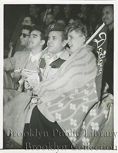 George Young & Helen Hickling, So. Berlin, N.Y., huddled up in Ebbets Field against cold