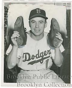 [Pee Wee Reese holding up shoes]