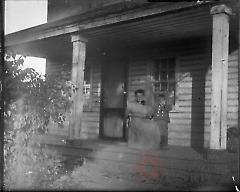 [Woman and boy on porch]