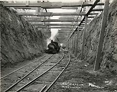 [Worker and locomotive in subway tunnel]