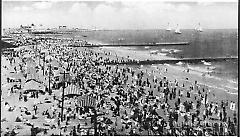 [Coney Island beach, with cabanas and piers]