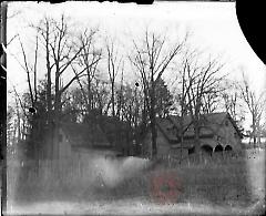 [House and barns in trees]