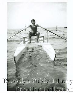 [Boy rowing pontoon boat]