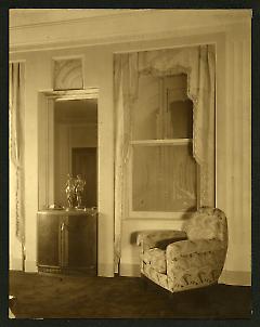 Weil-Worgelt apartment; upholstered chair in front of Art Deco patterned window.